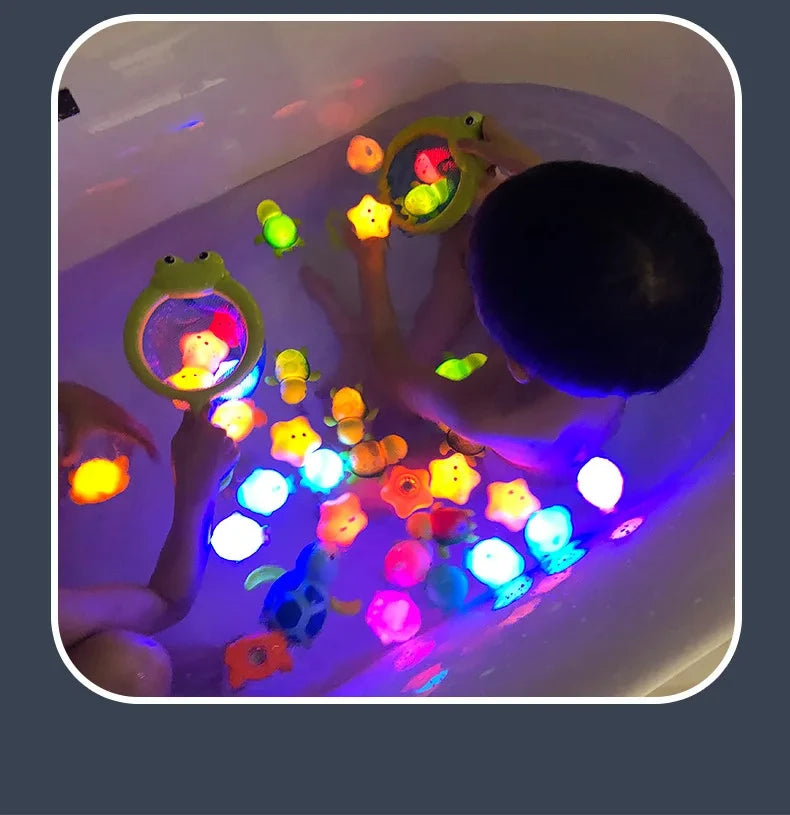 A child is playing with glow-in-the-dark animal washing water toys in a bathtub filled with glowing water.