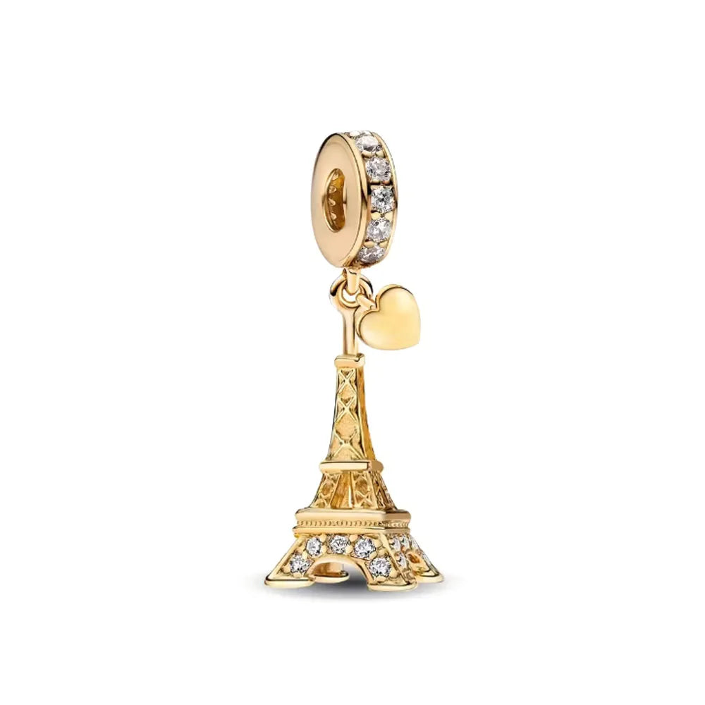 A gold charm bracelet featuring pendants of an elephant, key, butterfly, and heart.