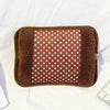 A brown, fuzzy hot water bottle with a brown cover and a square section of brown fabric dotted with white circles.