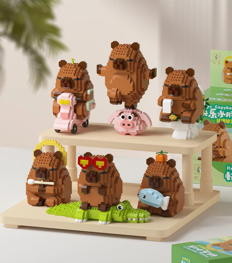 A set of cute brown bear micro building blocks featuring a capybara theme, displayed on a wooden shelf.