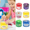 A child is playing with various colored slime putty toys including lemon, cherry, and kiwi flavors.