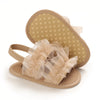 Pair of beige soft cotton baby walking shoes with anti-slip soles and sheer fabric bow detail
