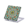 A folding mirror with a leather cover decorated in a diamond art pattern featuring green, orange, and yellow stones.