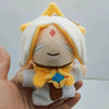 A soft yellow and white plush pendant featuring a doll-like character with a crown and facial markings.