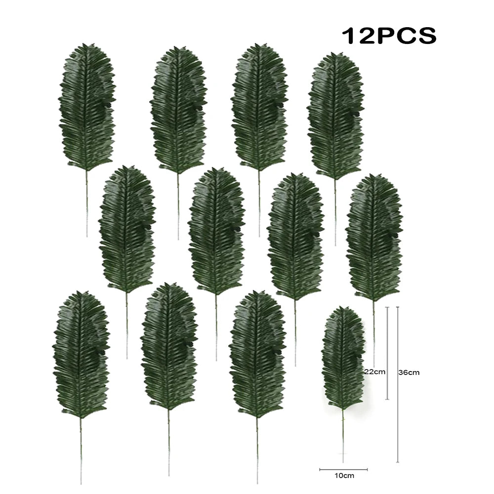 Twelve artificial tropical palm leaves in various shades of green displayed against a white background.