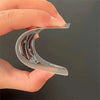 A hand holds a transparent plastic card shaped like a playing card, showing the design on its surface.