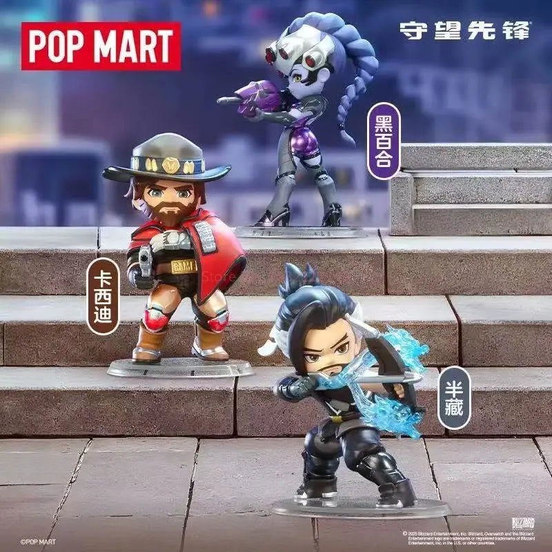 A collectible PVC figurine of a character in Overwatch, displayed on stone steps.