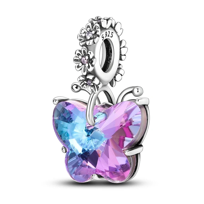 A silver heart charm bead featuring a pink zircon and floral detailing.