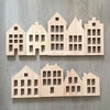 A wooden puzzle featuring a row of stylized houses or buildings cut from light wood.
