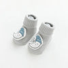 A pair of light gray cotton socks for babies featuring a cartoon sleeping face design.
