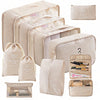 A set of beige travel packing cubes and storage bags with internal compartments.