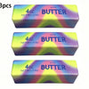 Three identical butter stick squishy toys in various pastel colors and packaging.