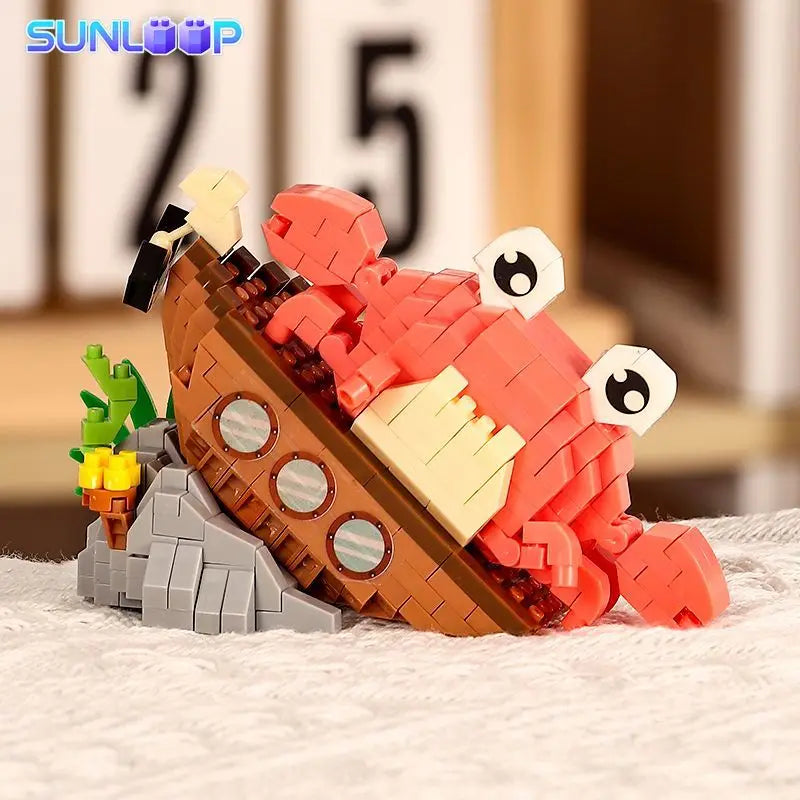 A set of orange and red building blocks shaped like a shark, crab, and clownfish for a STEM toy.