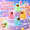 A collection of cute bear squishy toys in various colors and glitter textures displayed on purple stands.