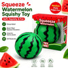 A green watermelon squishy toy ball with black stripes is shown next to its packaging box.