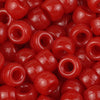 A close-up view of small, glossy red pony beads for jewelry making and crafts.