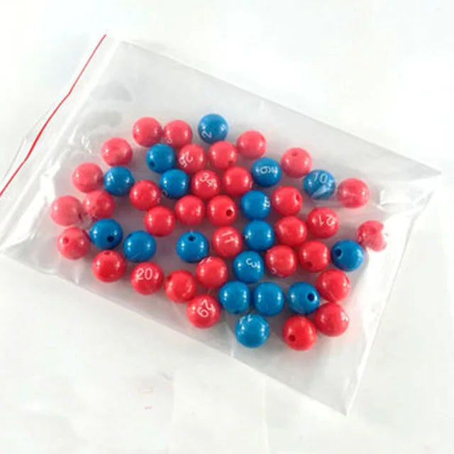 A collection of red and blue numbered balls for bingo and lottery games contained in a clear plastic bag.
