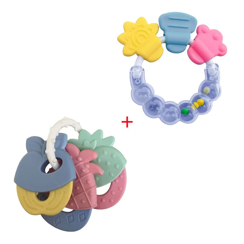 A set of silicone baby teethers in various colors including yellow, pink, and blue, arranged on a white background.