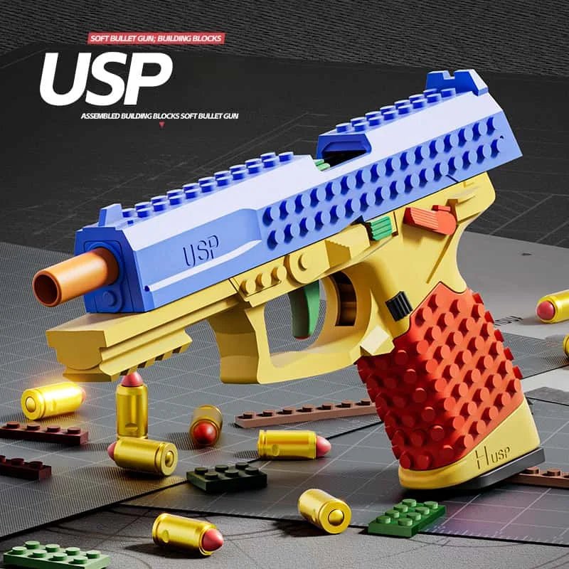 A yellow and blue building block toy gun is shown with various yellow and red ammunition pellets on a dark surface.