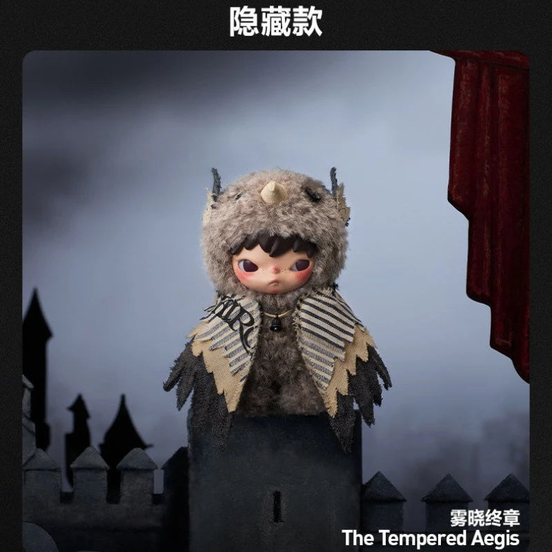 A small, fuzzy plush doll resembling a creature with large eyes and striped fabric accents stands in front of a castle silhou