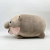 A soft brown pygmy hippo plush toy with large ears and a pink snout is shown from the side.