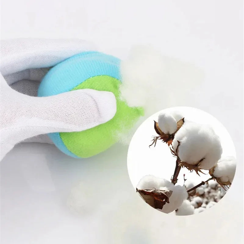 A hand is squeezing a bright blue and lime green sticky dodgeball vest for kids, with white fluff particles visible.