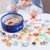 A collection of wooden magnetic fishing game pieces and a child playing with them.
