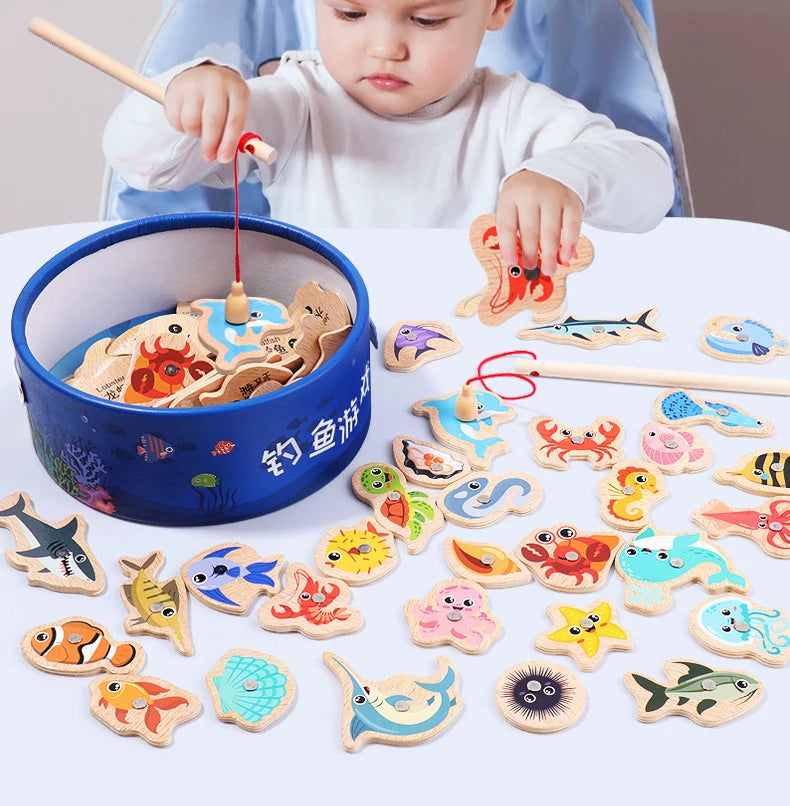 A collection of wooden magnetic fishing game pieces and a child playing with them.