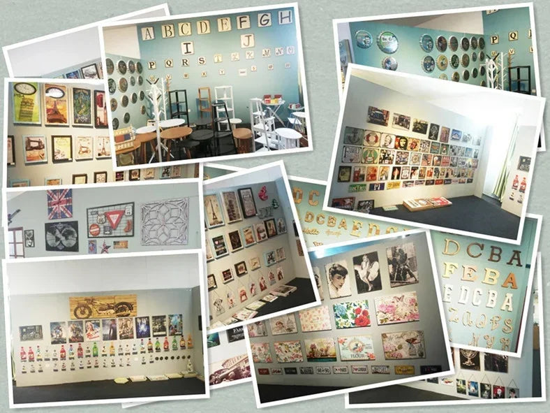 A collection of vintage metal wall signs and framed artwork displayed on a light-colored wall.