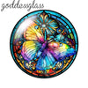 A round glass cabochon featuring a vibrant, iridescent butterfly design with blue, purple, and yellow tones.