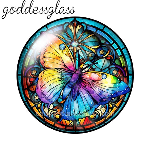 A round glass cabochon featuring a vibrant, iridescent butterfly design with blue, purple, and yellow tones.