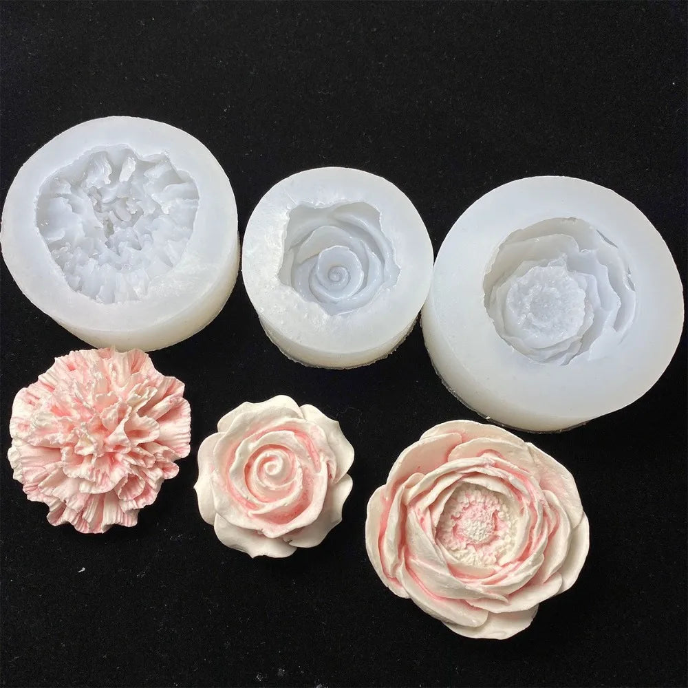Several white silicone molds shaped like roses are displayed on a black background.
