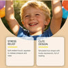 A smiling young boy holds up his arms, showing a cute dumpling squishy stress relief toy.