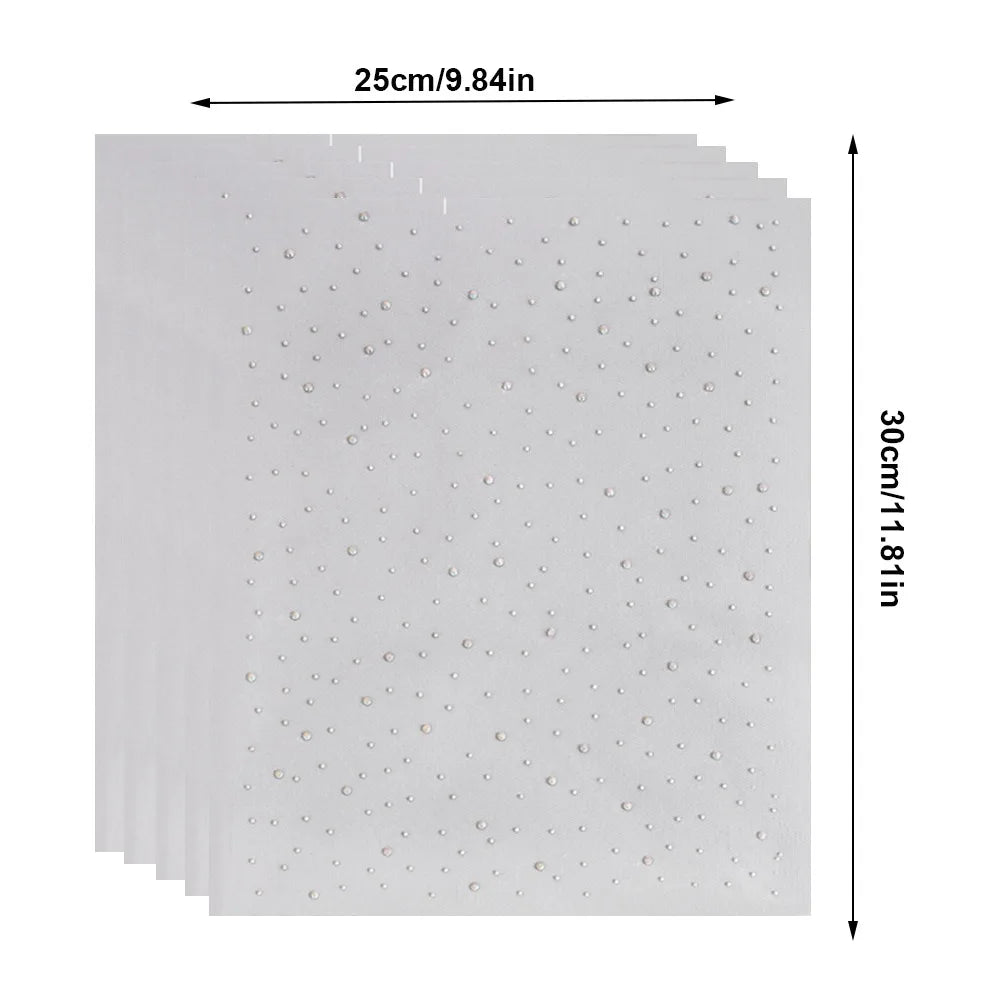 A sheet of white rhinestone sticker dots with dimensions 25cm by 30cm.