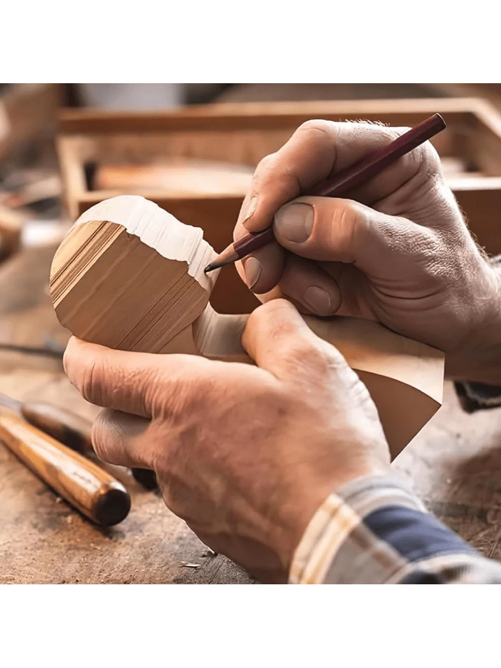 Hands are carving a piece of wood using a pencil on a basswood carving block.