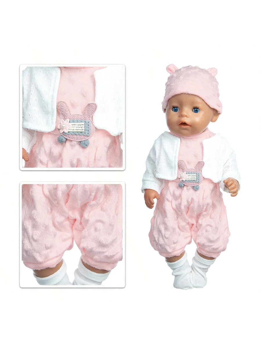 A baby doll wearing a pink outfit set with a cat print shirt and a matching hat.