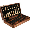 A handcrafted wooden folding chess set with solid walnut pieces displayed in an open wooden box.