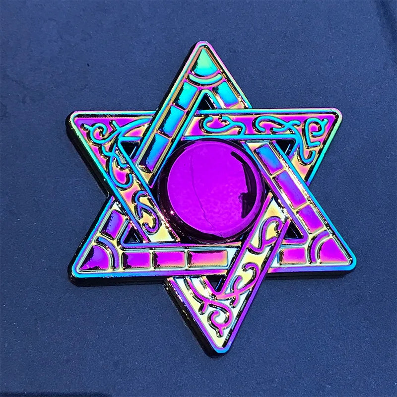 A purple and iridescent metal fidget spinner shaped like a five-pointed star with intricate patterns.