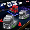A red and white 1:64 scale RC drifting truck is displayed on a desk with other similar models.