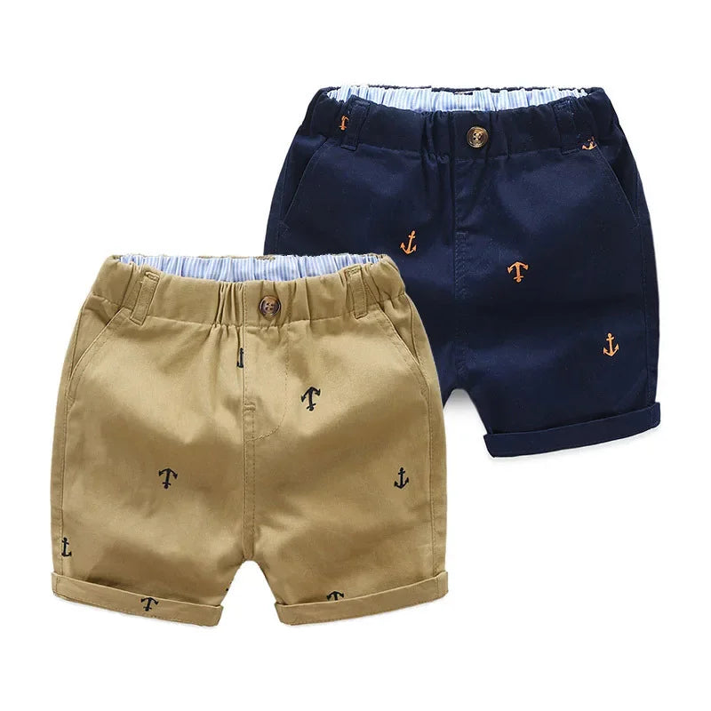 Navy blue and khaki cotton beach shorts for boys featuring an anchor print