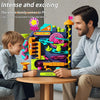 A father and son play with a multi-layer rolling ball track adventure toy for kids.
