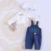 A set of white long-sleeved shirt and a light blue knitted hat for a doll dress-up outfit.