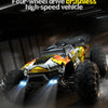A black and yellow four-wheel drive brushless high-speed RC monster truck with bright LED lights on a dark surface.