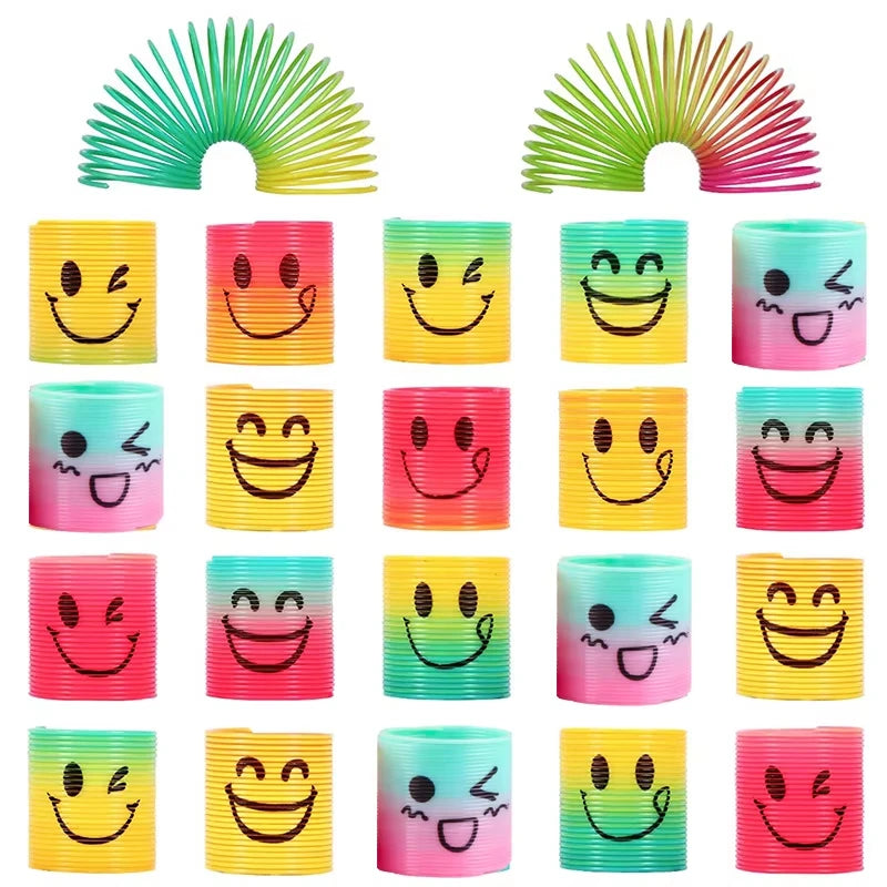 A collection of colorful Halloween pumpkin coil spring toys for party favors in various shades of yellow, green, and pink.