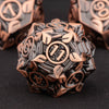 A close-up of a bronze metal die with intricate engravings, set against a dark background.