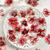 White ceramic plate decorated with red and pink floral hot stamp stickers for journaling