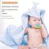 A baby is using a soft elastic odorless silicone teether toy while wrapped in a light blue towel.
