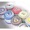 A collection of colorful gradient rainbow yarn spools in various shades and textures for knitting and crochet.