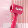 A pink hair dryer with a salon nozzle and a power cord, shown against a light pink background.