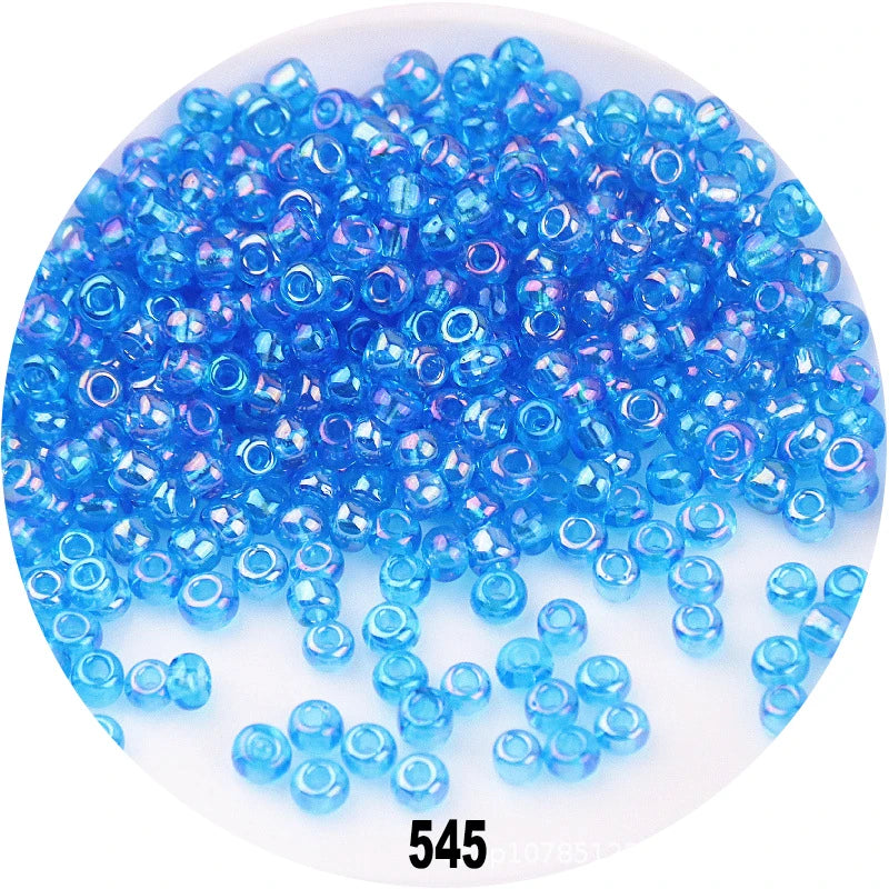 A pile of bright blue round glass seed beads for jewelry making
